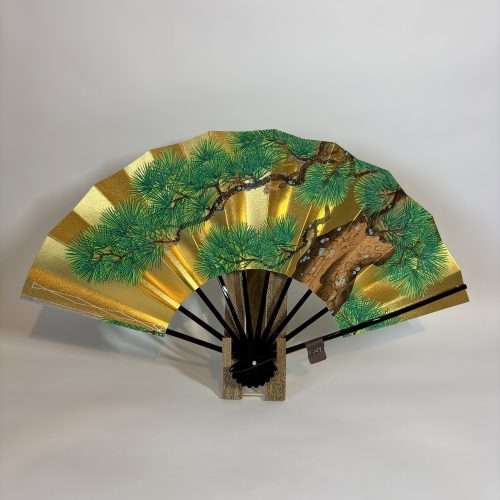 traditional japanese decorative folding fan with pine tree design